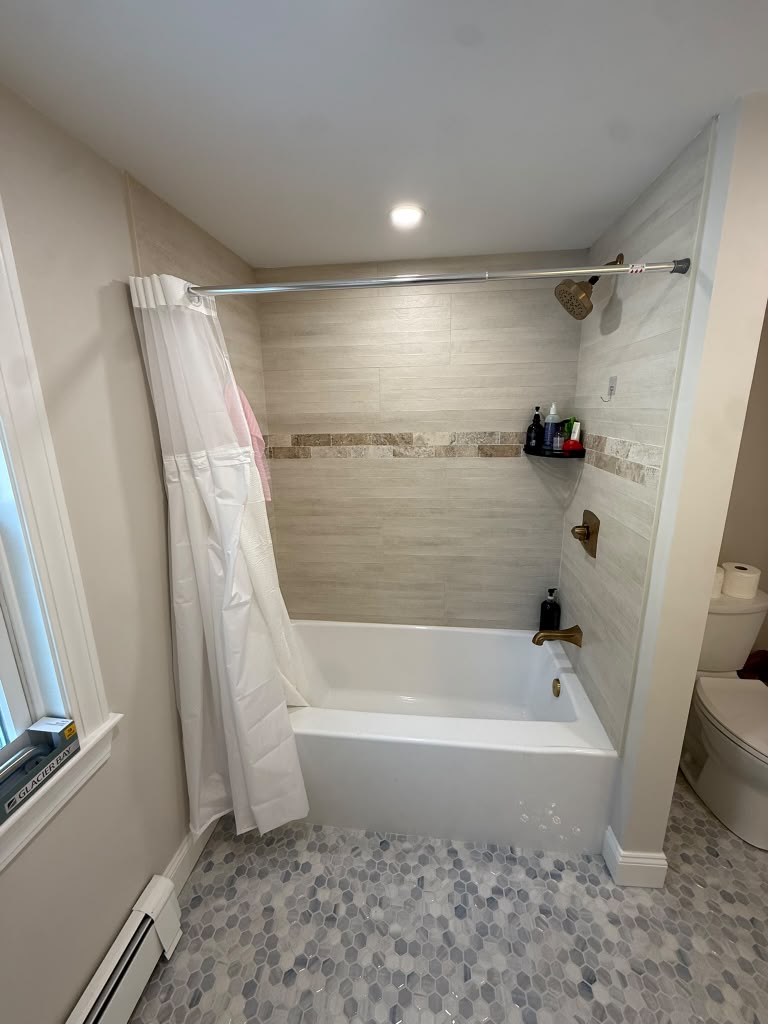 Finished bathroom remodel with new tub surround and tile