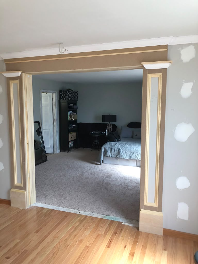 Wide cased opening with custom pilasters and header trim